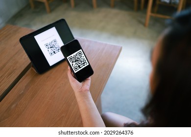 Qr code payment. E wallet. Woman scanning QR code online shopping cashless technology concept