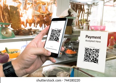 Qr Code Payment , Online Shopping , Cashless Technology Concept. Restaurant In Market Accepted Digital Pay Without Money , Plastic Tag On Table And Hand Using Mobile Phone Application To Scan Qr Code.