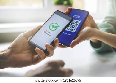 qr code payment - person paying with mobile phone - Shutterstock ID 1931626895
