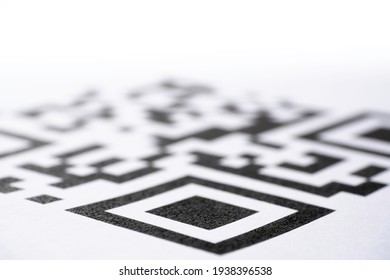 QR code printed on paper. Macro image. Focus on the bottom of the code, blurred gradient