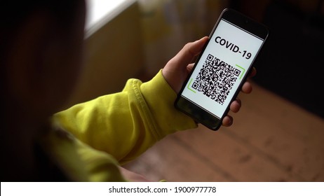 QR code scan and COVID-19. Personal QR code with encrypted information on the smartphone screen. Data on movement, health status, contacts with people infected with coronavirus infection, vaccination