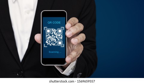 QR code scanning payment and verification. Businessman holding mobile smart phone scan QR code on screen