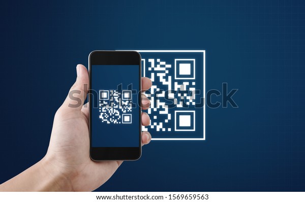 QR code scanning payment and\
verification. Hand using mobile smart phone scan QR\
code