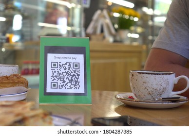 QR Code Touch-free Payment Display In The Retail Store. To Use A QR Code Payment The Consumers Scans The QR Code Displayed By The Merchant With Their Phones To Pay For Their Goods. Shopping