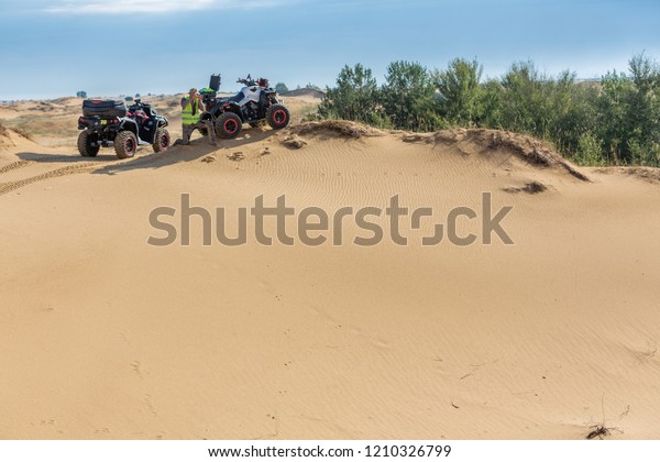 quad bike in the desert, utv buggy in the\
desert, ATV races, baja, quad side by side rides through the\
desert, desert\
competitions\
