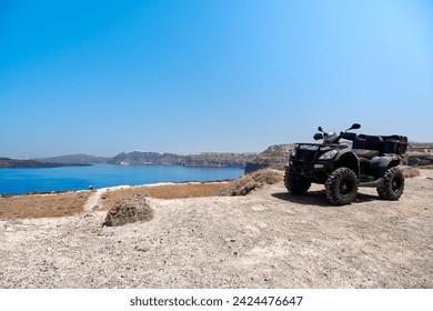 Quad bike parked on the seafront of the Akrotiri peninsula in the southwestern part of the island of Santorini with a view of the caldera. Travel, relaxation, adventure. - Powered by Shutterstock