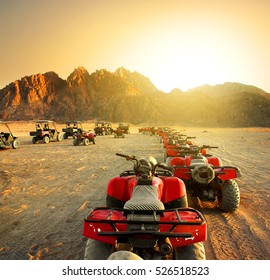 Quad Bikes In Desert At The Sunset