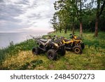 quad bikes in nature. forest summer water. headlights and wheels