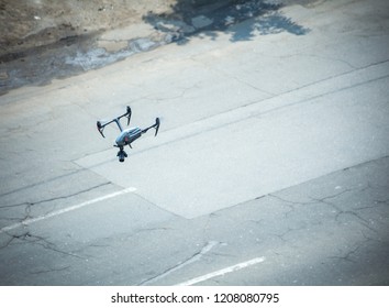 Quadcopter UAV`s Drone For Commercial Aerial Photography Flying Over Old Motorway Examines The Defects Of The Road Surface.