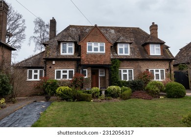 Quaint English brick built detached cottage style residence, with dormers and front facing gables - Shutterstock ID 2312056317