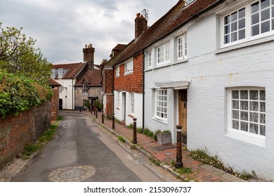 Quaint narrow picturesque street featuring downland flint walls with traditional terraced cottages in Lewes, East Sussex
