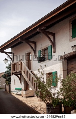 Quaint old European village home with green shutters.