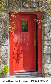 A Quaint Open Red Door.