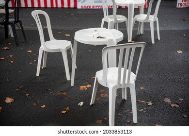 Quaint Village Street Fair Pop Up Restaurant Scene With Wet Cafe Tables On An Asphalt Street. Natural Light No People With Copy Space.