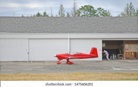 Qualicum Beach, Canada - July 31, 2019: A Man Parks A Vans RV7 Airplane In A Hangar After A Flight. Suitable To Illustrate Aviation, Private Airplanes, Hobbies, Or Private Aircraft Ownership.