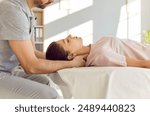 Qualified chiropractor, osteopath or manual therapist a young female patient to relax her tense shoulder muscles and to relieve neck pain. Chiropractic, osteopathy, therapy, treatment concept