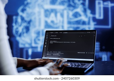 Qualified technician updates neural networks made up of interconnected nodes, writing intricate binary code scripts on laptop. Skilled expert uses programming to upgrade AI simulation model - Powered by Shutterstock - Get 15% off with code: PIKWIZARD15