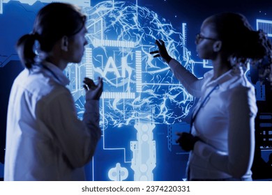 Qualified technicians brainstorm ways to use AI cognitive computing to extract usable information from complex data. Team of specialists implement artificial intelligence to process massive datasets