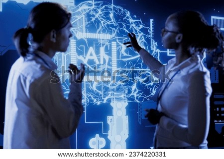 Qualified technicians brainstorm ways to use AI cognitive computing to extract usable information from complex data. Team of specialists implement artificial intelligence to process massive datasets