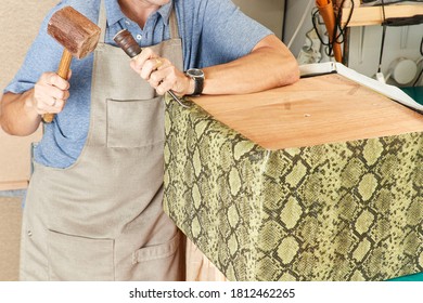 Qualified workman upholstering furniture in repair furniture workshop - Powered by Shutterstock