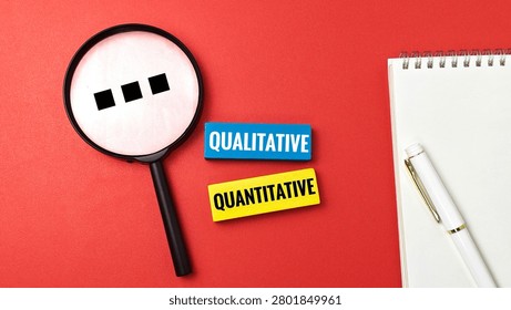 Qualitative and Quantitative Research Method Concept with Magnifying Glass on Red Background for Data Analysis Statistics Information Study. 