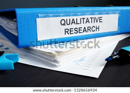 Qualitative research methods report in a blue folder. Foto d'archivio © 