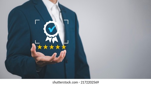 Quality assurance of business services, Businessman Hand shows the sign of the top service Quality assurance in Black background , Guarantee, Standards, ISO certification and standardization concept. - Shutterstock ID 2172202569
