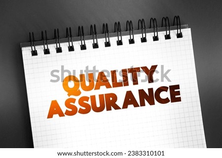 Quality Assurance - systematic process of determining whether a product or service meets specified requirements, text on notepad, concept background
