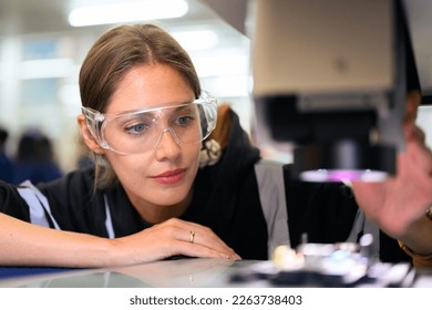 Quality control engineer specialist checking and inspecting circuit board at electronic factory - Powered by Shutterstock