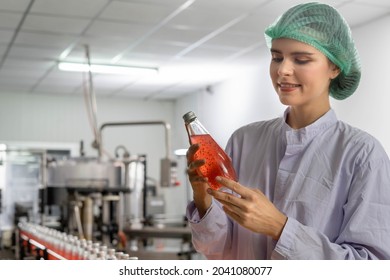 Quality Control Engineers Work In The Production And Bottling Facility For Fruit Juice Or Medicine. Staff Inspect The Quality Of Food And Drugs Before Delivery To Customers.