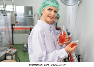 Quality control engineers work in the production and bottling facility for fruit juice or medicine. Staff inspect the quality of food and drugs before delivery to customers.
