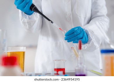 Quality control expert examines beer in a modern laboratory - Powered by Shutterstock