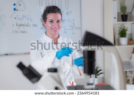 A quality control expert examines pudding samples in a laboratory