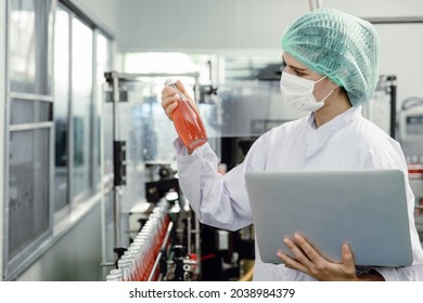 Quality control and food safety inspector test and check product contaminate standard in the food and drink factory production line with hygiene care. - Shutterstock ID 2038984379