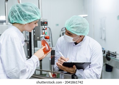 Quality Control And Food Safety Team Inspection The Product Standard In The Food And Drink Factory Production Line.