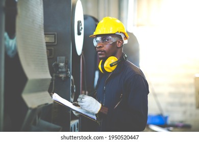 Quality Control Inspector Checking Workers At Factory. Engineering Worker Team Working In Heavy Industry Manufacturing Facility. Engineer Operating Lathe Machinery. American African People.