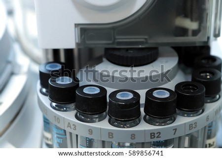 Quality Control Laboratory medicine. Chromatograph operation. Vials on autosampler of gas chromatography-mass spectrophotometer. Ampoules are chemical control suspension in the gas chromatograph