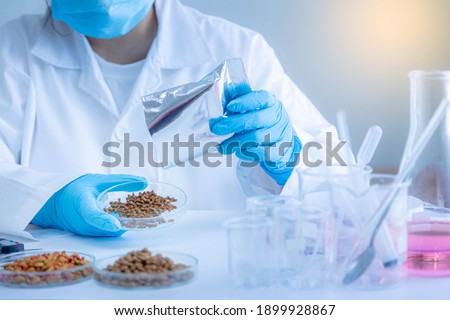 Quality control personnel are inspecting the quality of pet food. Quality control process in pet food industry.