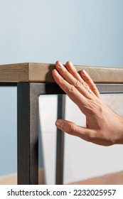 Quality control of the production of a table in the loft style, a man's hand touches the table