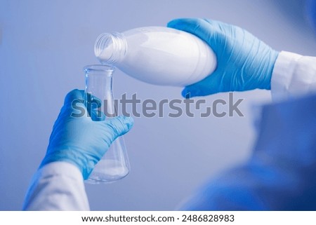 Quality control test of milk in laboratory. Dairy factory industry products.
