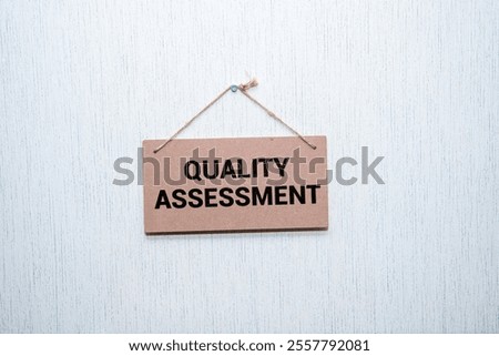 QUALITY CONTROL text on sticker on blue background with pen and keyboard