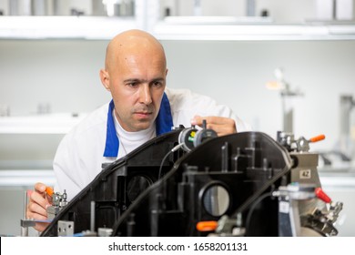 Quality engineer measuring plastic components by digital meter on the fixture, automotive and metrology concept