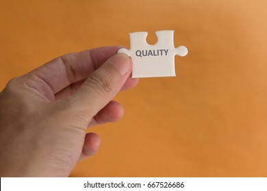 Quality Management Concept , hand pick up a piece of jigsaw with word quality - Shutterstock ID 667526686