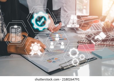 Quality Management With QA (assurance), QC (control) And Improvement, Business Team Discussing Data With Document Data With VR Screen Quality Management Icon On Desk Table.