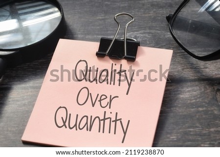 Quality Over Quantity wording with magnifying glass. Management concept