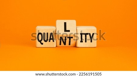 Quality and quantity symbol. Concept word Quality Quantity on wooden cubes. Beautiful orange table orange background. Business and quality and quantity concept. Copy space.