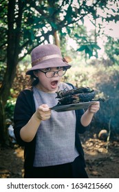 Quang Nam, Vietnam - 23/02/2019: Countryside Girl. Rural Vietnam. Work In Garden. Daily Life. Hard Working. Eating Grilled Fish.