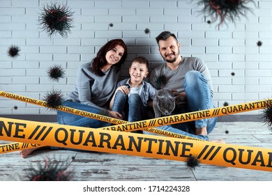 Quarantine Barrier Yellow Forbidden Tape, Isolation. Coronavirus. The Family Sits At Home And Particles Of The Virus COVID-19. The Concept Of A Ban On Leaving The House, Self-isolation