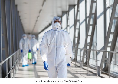 Quarantine, coronavirus infection. Disinfectant workers in protective mask and suit sprays bacterial or virus outdoor - Shutterstock ID 1679266777