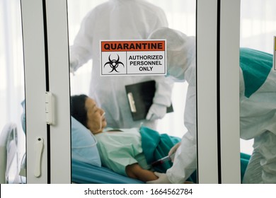 Quarantine signage in front of quarantine room. Doctors in personal protective equipment collecting blood from a female elderly patient in control area. Coronavirus COVID 19 quarantine area. - Shutterstock ID 1664562784